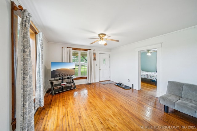 11029 N 3670th Rd, Okemah, OK 74884 - living room featuring ceiling fan, wood-type flooring, ornamental molding, and baseboards