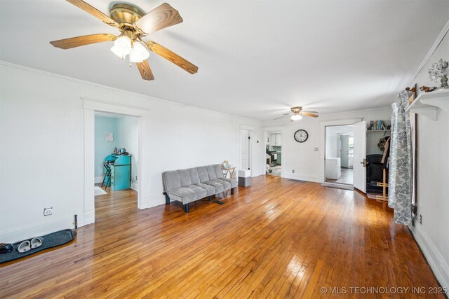 11029 N 3670th Rd, Okemah, OK 74884 - living area featuring a ceiling fan, light wood-style floors, baseboards, and crown molding