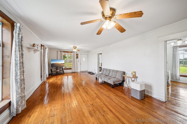 11029 N 3670th Rd, Okemah, OK 74884 - living room with plenty of natural light, a ceiling fan, light wood-style flooring, and crown molding
