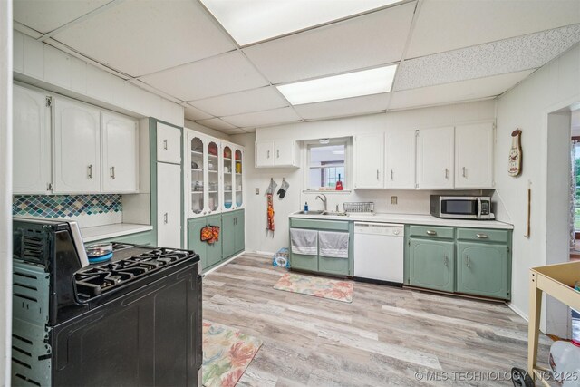 11029 N 3670th Rd, Okemah, OK 74884 - kitchen featuring dishwasher, black gas range, stainless steel microwave, light countertops, and a paneled ceiling