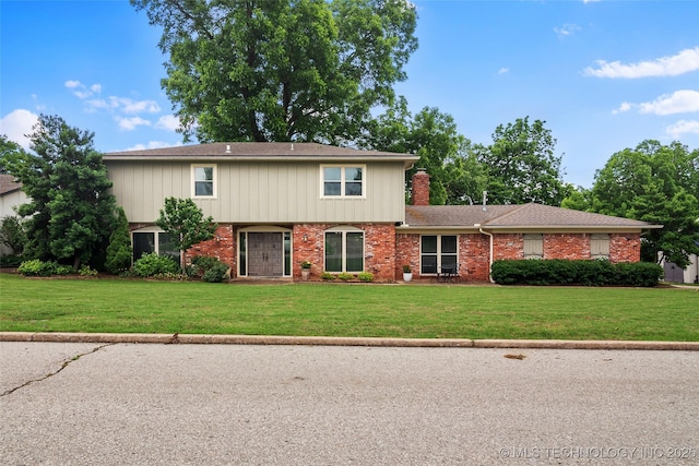 8313 Shadowood Ave, Broken Arrow, OK 74011 - view of front of property featuring a front yard, a chimney, and brick siding