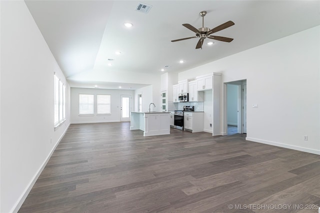 304 S 25th St, Collinsville, OK 74021 - unfurnished living room featuring a ceiling fan, baseboards, recessed lighting, dark wood-type flooring, and a sink