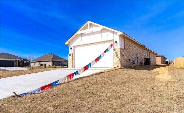 304 S 25th St, Collinsville, OK 74021 - view of front of property with board and batten siding, brick siding, central AC, driveway, and an attached garage