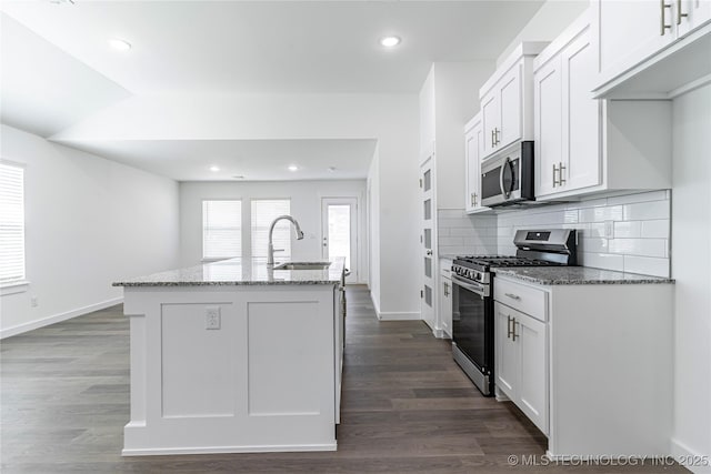 304 S 25th St, Collinsville, OK 74021 - kitchen with stainless steel appliances, a sink, light stone countertops, a kitchen island with sink, and white cabinetry
