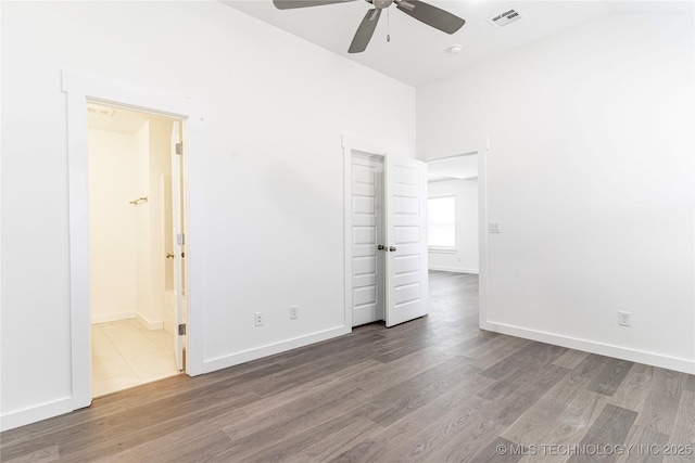 304 S 25th St, Collinsville, OK 74021 - unfurnished bedroom featuring wood finished floors, baseboards, connected bathroom, and ceiling fan