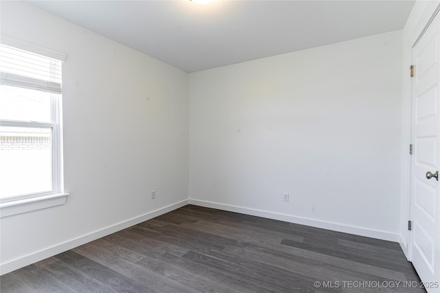304 S 25th St, Collinsville, OK 74021 - empty room with healthy amount of natural light, dark wood-type flooring, and baseboards