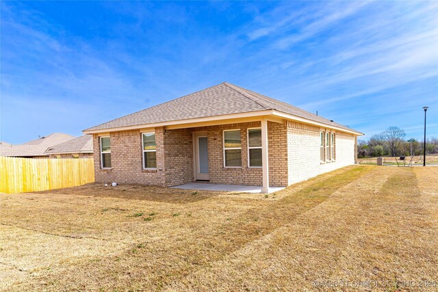 304 S 25th St, Collinsville, OK 74021 - rear view of property featuring brick siding, a patio area, and a shingled roof