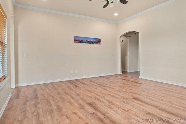 1204 Gantt, Marietta, OK 73448 - spare room featuring arched walkways, a ceiling fan, light wood-style flooring, ornamental molding, and baseboards