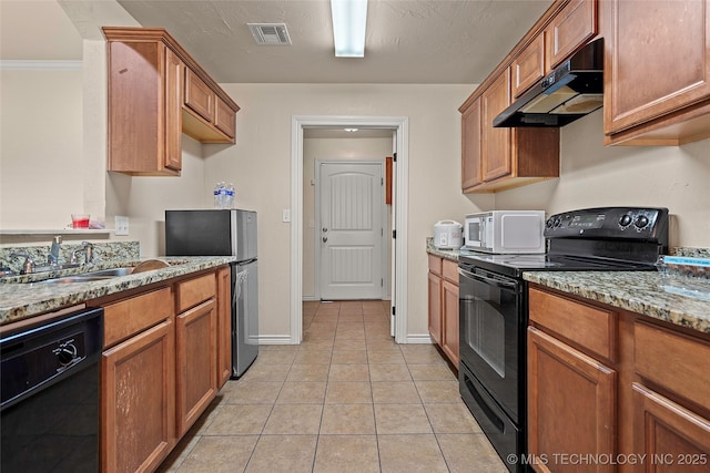 1204 Gantt, Marietta, OK 73448 - kitchen with black appliances, under cabinet range hood, a sink, brown cabinets, and light tile patterned floors