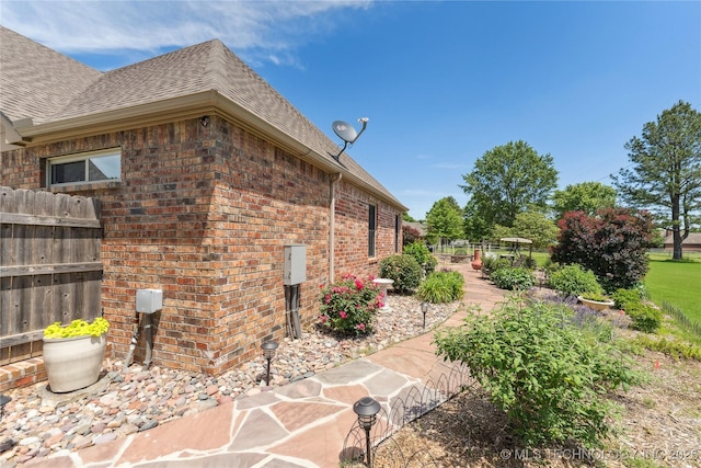 21542 E 103rd St S, Broken Arrow, OK 74014 - view of side of property featuring roof with shingles and brick siding