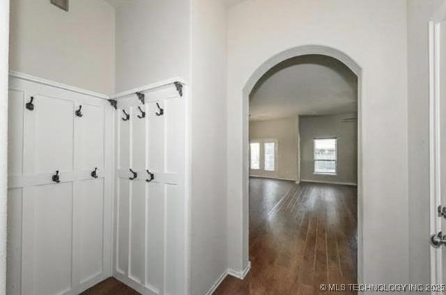 15610 E 91st St, Owasso, OK 74055 - corridor featuring arched walkways and dark wood-style floors