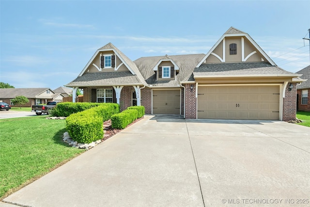 15610 E 91st St, Owasso, OK 74055 - view of front facade with brick siding, concrete driveway, a front yard, and an attached garage