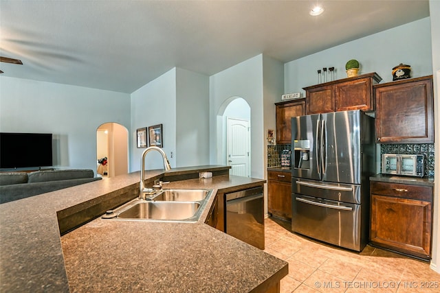 15610 E 91st St, Owasso, OK 74055 - kitchen featuring stainless steel fridge, arched walkways, dishwashing machine, tasteful backsplash, and light tile patterned floors