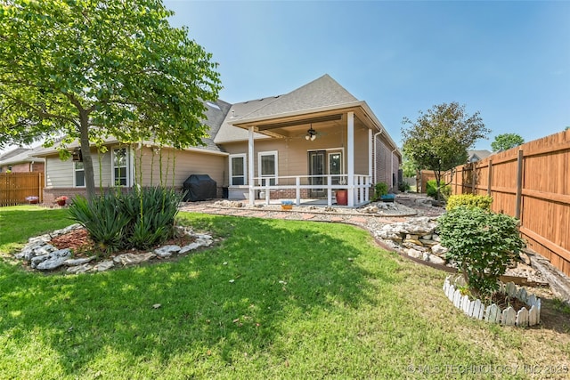 15610 E 91st St, Owasso, OK 74055 - back of property with a ceiling fan, a fenced backyard, a patio area, and a shingled roof
