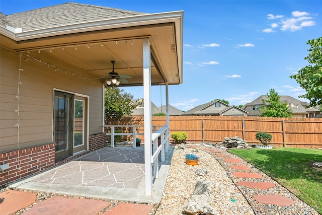 15610 E 91st St, Owasso, OK 74055 - fenced backyard with ceiling fan and a patio