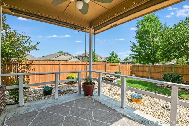 15610 E 91st St, Owasso, OK 74055 - fenced backyard featuring a ceiling fan and a patio