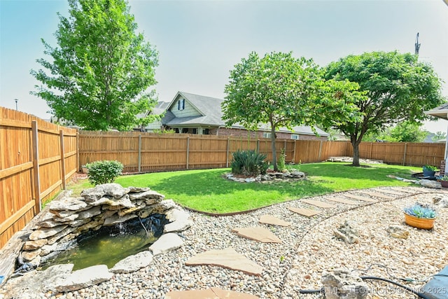 15610 E 91st St, Owasso, OK 74055 - fenced backyard featuring a garden pond