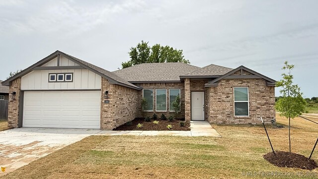 14984 S Oak St, Glenpool, OK 74033 - view of front of home featuring roof with shingles, a garage, a front yard, and driveway