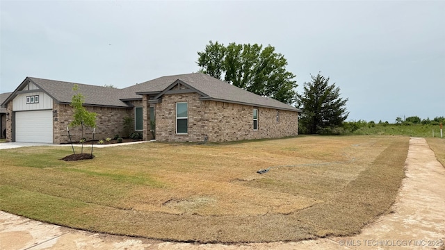 14984 S Oak St, Glenpool, OK 74033 - view of front of home featuring brick siding, a front lawn, a garage, concrete driveway, and roof with shingles