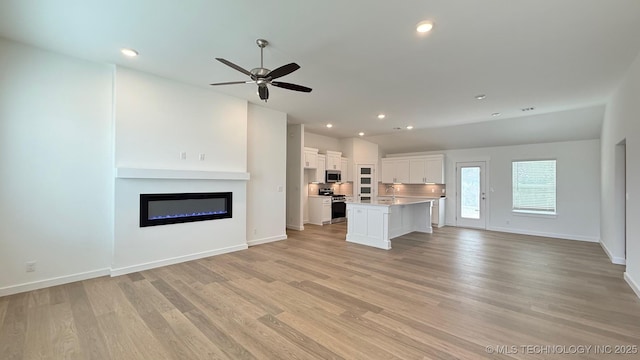 14984 S Oak St, Glenpool, OK 74033 - unfurnished living room with a glass covered fireplace, a ceiling fan, light wood-style floors, baseboards, and recessed lighting