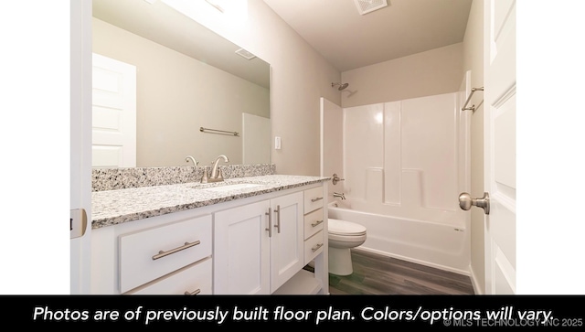 1411 E 149th Pl S, Glenpool, OK 74033 - bathroom with toilet, wood finished floors, vanity, and tub / shower combination