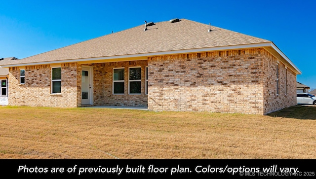 1411 E 149th Pl S, Glenpool, OK 74033 - rear view of house with a lawn, a shingled roof, and brick siding
