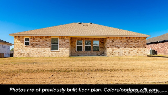 1411 E 149th Pl S, Glenpool, OK 74033 - back of property featuring central AC unit, brick siding, a yard, and a shingled roof