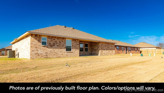 1411 E 149th Pl S, Glenpool, OK 74033 - rear view of property with central AC unit, a yard, brick siding, and a shingled roof