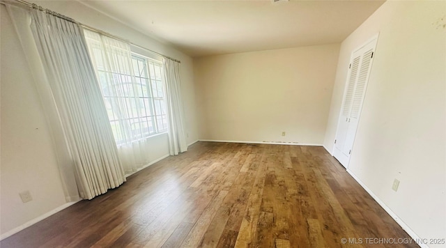 3405 S 85th E Ave, Tulsa, OK 74145 - unfurnished bedroom featuring wood finished floors, baseboards, and a closet