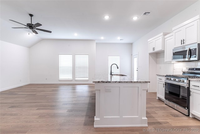 27790 E 109th Pl S, Coweta, OK 74429 - kitchen with appliances with stainless steel finishes, a sink, ceiling fan, light stone counters, and white cabinets