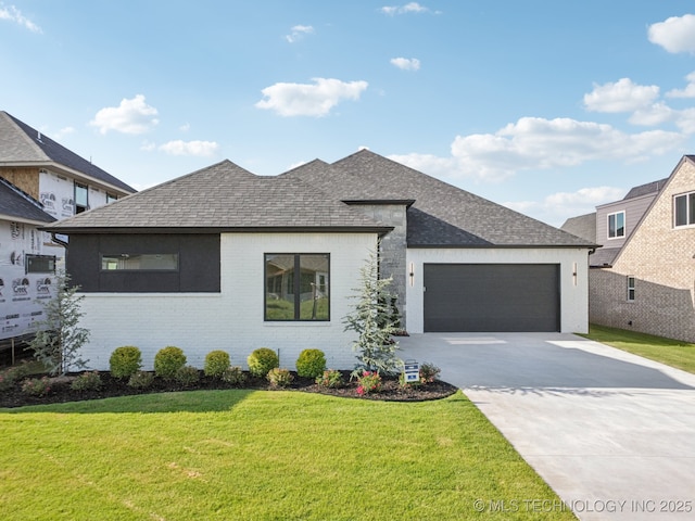 2357 E 134th Cir, Bixby, OK 74008 - view of front of home with a garage, concrete driveway, a front lawn, and a shingled roof