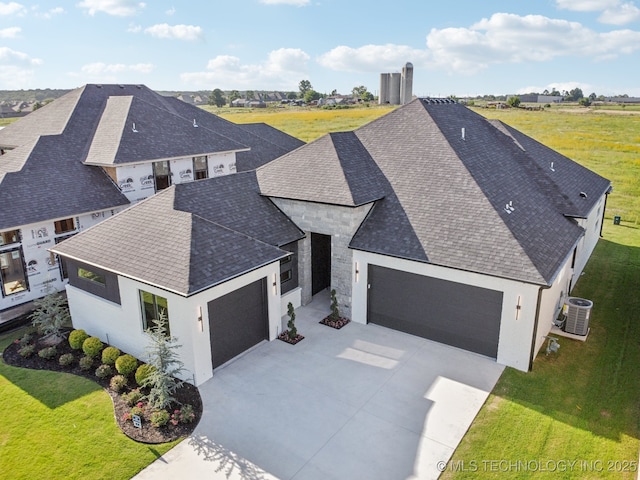 2357 E 134th Cir, Bixby, OK 74008 - view of front of property featuring a garage, concrete driveway, a shingled roof, a front yard, and stucco siding