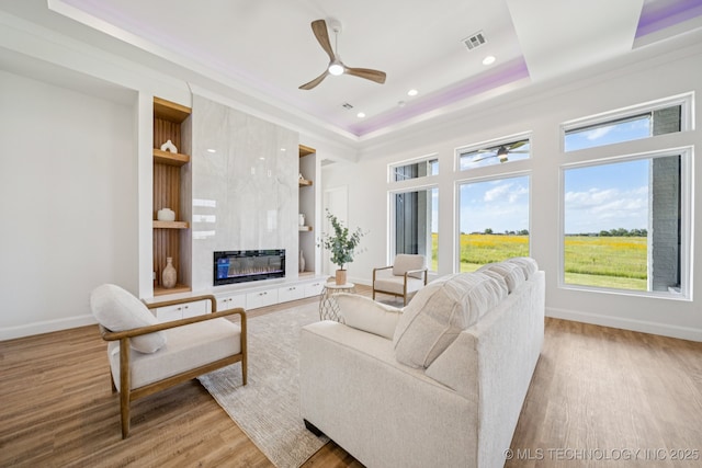 2357 E 134th Cir, Bixby, OK 74008 - living room with a ceiling fan, wood finished floors, plenty of natural light, a fireplace, and crown molding