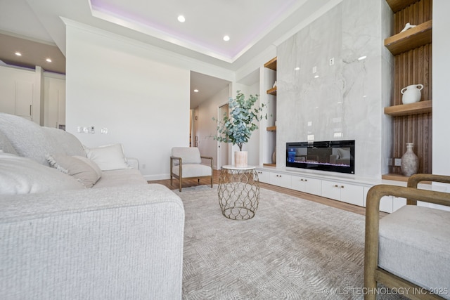 2357 E 134th Cir, Bixby, OK 74008 - living room featuring built in features, recessed lighting, a premium fireplace, and wood finished floors
