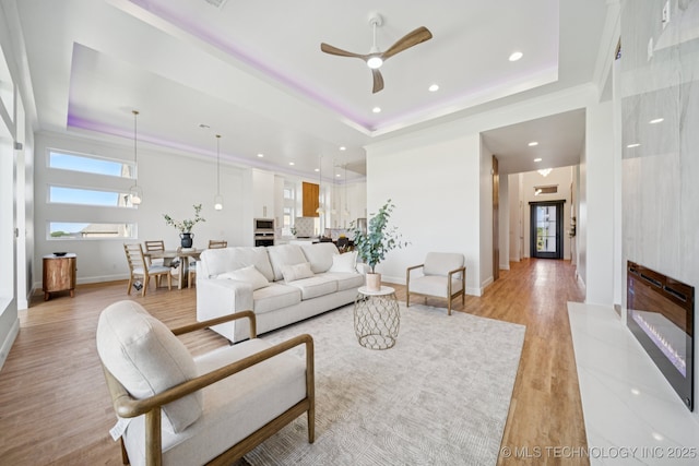 2357 E 134th Cir, Bixby, OK 74008 - living area featuring a raised ceiling, light wood finished floors, ceiling fan, recessed lighting, and ornamental molding