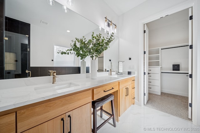2357 E 134th Cir, Bixby, OK 74008 - full bathroom featuring marble look tiles, double vanity, and a spacious closet