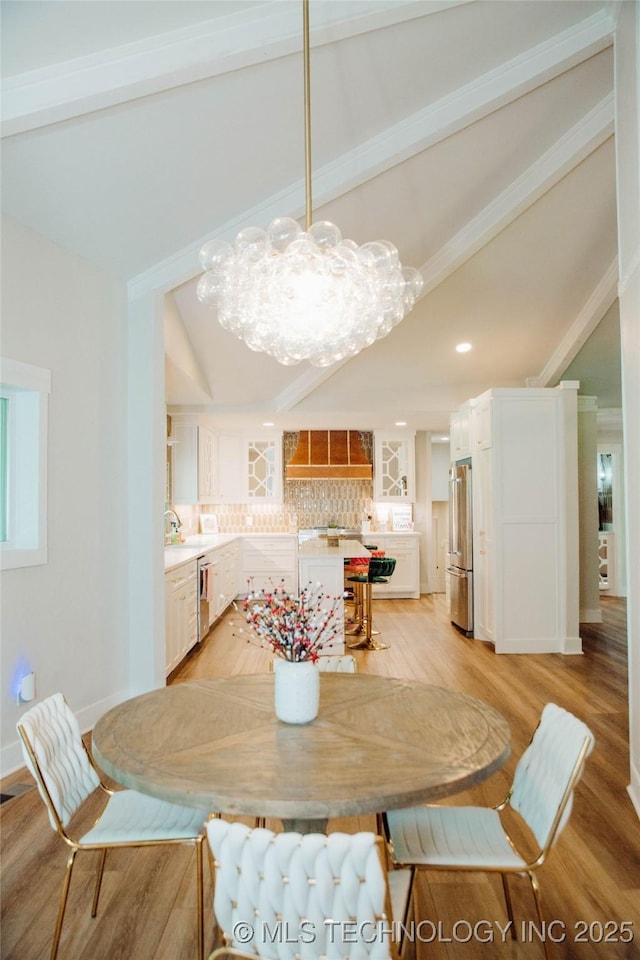 2232 Gershwin Dr, Durant, OK 74701 - dining area featuring light wood-type flooring, a chandelier, and baseboards