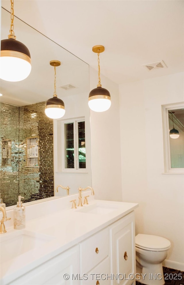 2232 Gershwin Dr, Durant, OK 74701 - bathroom featuring double vanity, a stall shower, and toilet