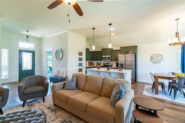 11022 S 276th E Ave, Coweta, OK 74429 - living area featuring wood finished floors, a chandelier, baseboards, and a ceiling fan