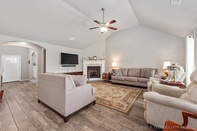 10101 S 232nd E Ave, Broken Arrow, OK 74014 - living area with lofted ceiling, arched walkways, ceiling fan, wood finished floors, and a fireplace