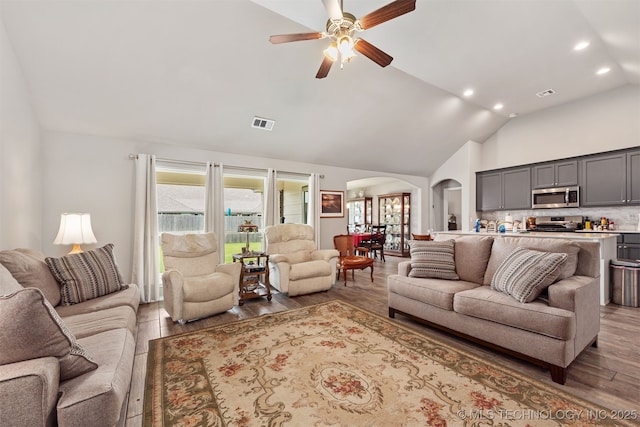 10101 S 232nd E Ave, Broken Arrow, OK 74014 - living room with arched walkways, wood finished floors, a ceiling fan, recessed lighting, and high vaulted ceiling