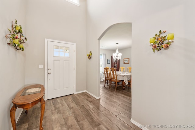 10101 S 232nd E Ave, Broken Arrow, OK 74014 - foyer with arched walkways, wood finished floors, and healthy amount of natural light