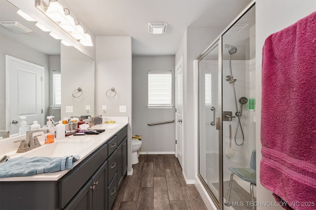 10101 S 232nd E Ave, Broken Arrow, OK 74014 - full bath with wood finished floors, a shower stall, vanity, toilet, and baseboards