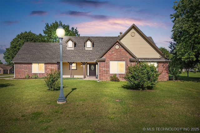 2101 S Buchanan Ave, Wagoner, OK 74467 - view of front of house featuring brick siding and a lawn