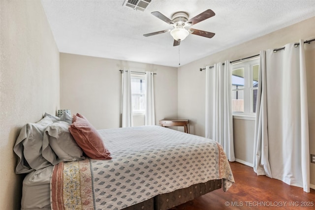 11200 E 112th St N, Owasso, OK 74055 - bedroom featuring dark wood-type flooring, a textured ceiling, a ceiling fan, and baseboards