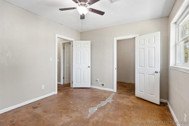 11200 E 112th St N, Owasso, OK 74055 - unfurnished bedroom with concrete floors, baseboards, and a ceiling fan