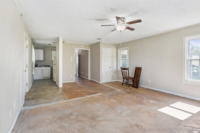 11200 E 112th St N, Owasso, OK 74055 - unfurnished living room featuring concrete flooring, a textured ceiling, a ceiling fan, and baseboards