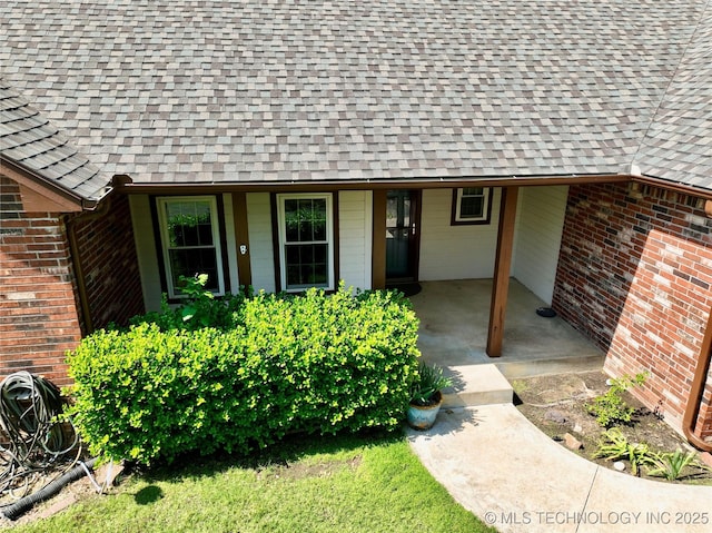 46 Acorn St, Eufaula, OK 74432 - view of exterior entry with a shingled roof and brick siding