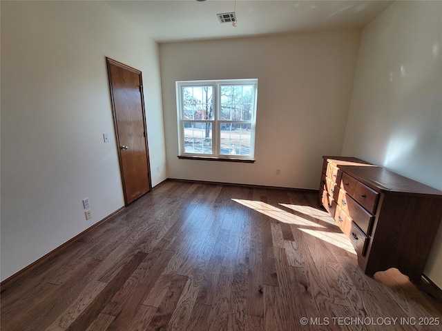 46 Acorn St, Eufaula, OK 74432 - unfurnished bedroom with dark wood-type flooring and baseboards
