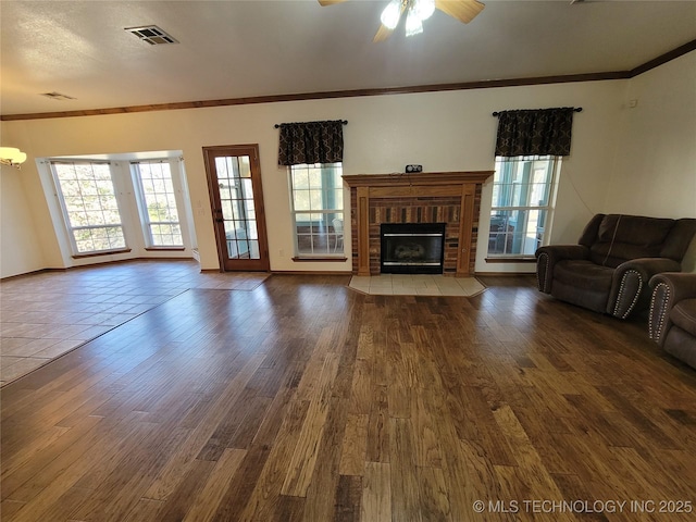 46 Acorn St, Eufaula, OK 74432 - living room with healthy amount of natural light, a ceiling fan, a brick fireplace, and crown molding